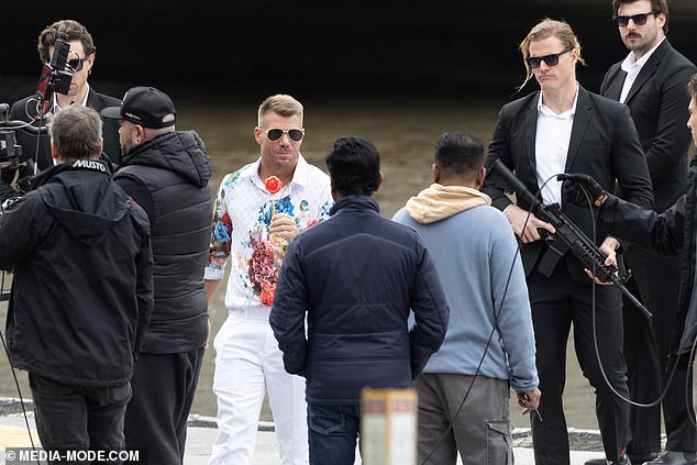 He terrorized the men in suits surrounding him on the floating pier, pretending to shoot one of them with his lollipop.