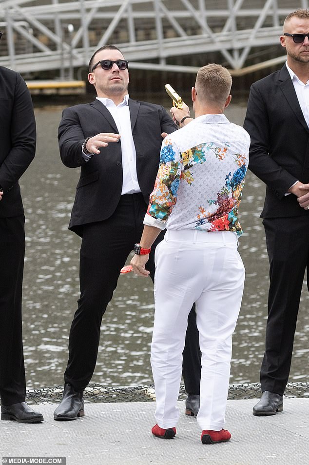 David wore a colorful floral shirt and white pants, which provided a stark contrast to his red shoes