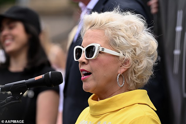 British transgender activist Kellie-Jay Keen-Minshull speaks on the steps of Parliament House in Melbourne on March 18, 2023. To her right is Victorian MP Moira Deeming.