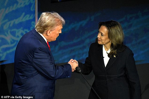 U.S. Vice President and Democratic presidential candidate Kamala Harris (R) shakes hands with former U.S. President and Republican presidential candidate Donald Trump during a presidential debate at the National Constitution Center in Philadelphia, Pennsylvania, on September 10, 2024.