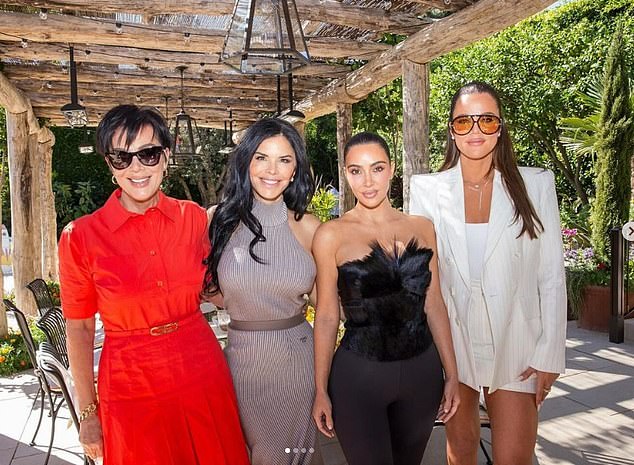 Kim and Khloe's mother Kris Jenner was seen on the far left in a red dress