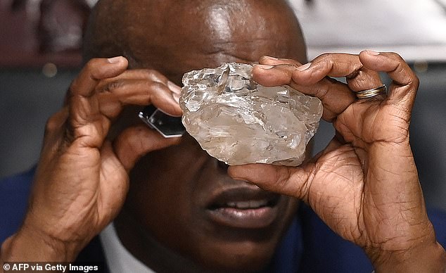 The largest gemstone ever found is the Cullinan Diamond, a 3,106-carat diamond discovered on January 26, 1905, at the Premier No. 2 Mine in Cullinan, South Africa, and owned by diamond magnate Sir Thomas Cullinan. PICTURED: Botswana President Mokgweetsi Masisi looks at a large diamond discovered in Botswana at his office in Gaborone on August 22, 2024.