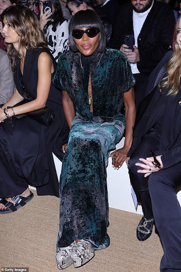 Naomi looked stunning in a green and black crinkled velvet dress, which she paired with statement sunglasses and snakeskin-print shoes