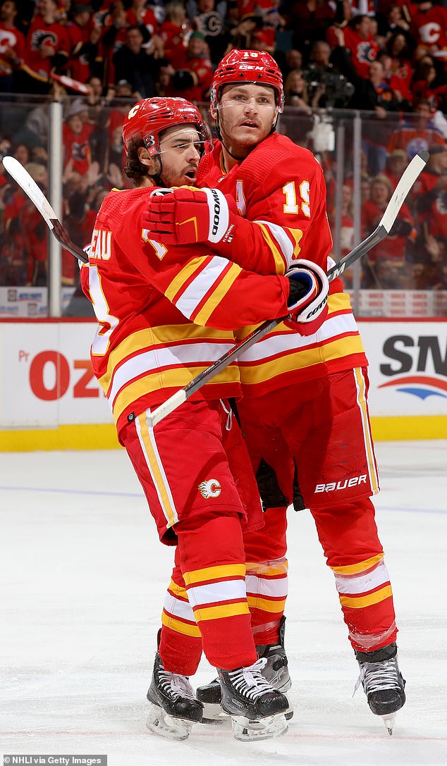 Johnny Gaudreau (left) and Matthew Tkachuk embrace during Calgary Flames days