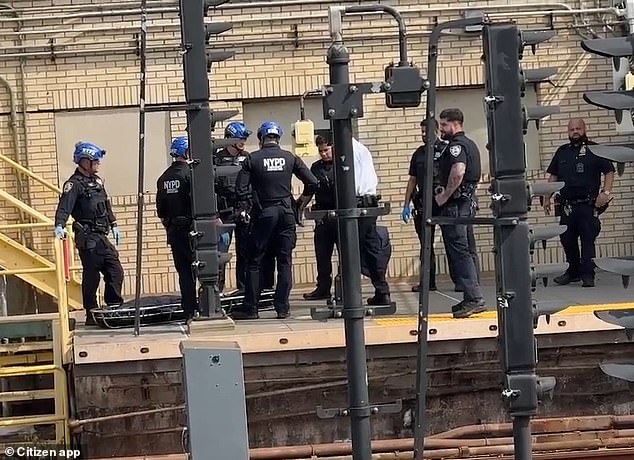 NYPD officers are seen near a covered stretcher after Monday's tragic incident. The child has not yet been identified