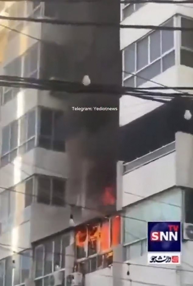 Flamed apartment buildings belch heavy black smoke as more explosions rock Beirut