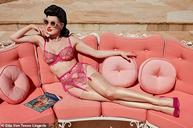 In another photo, she wore dark pink lingerie and sunglasses as she lay on a pink outdoor sofa