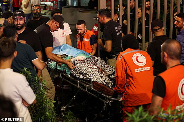 A person is carried on a stretcher outside the American University of Beirut Medical Center after Tuesday's attacks