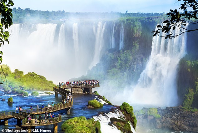 Tourists at Iguazu Falls, one of the world's greatest natural wonders, on the border of Brazil and Argentina