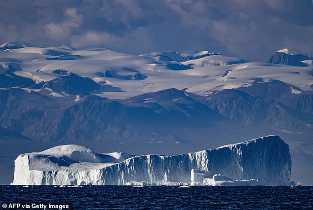 This photo, taken on August 16, 2023, shows an iceberg about a few hundred meters long, drifting along the Scoresby Sound Fjord in East Greenland