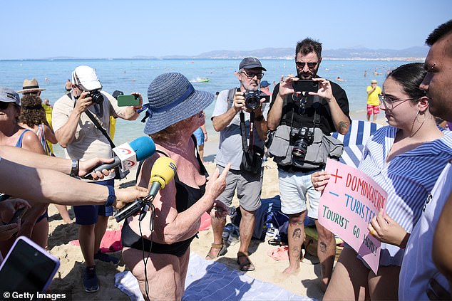 A protester speaks during the demonstration on the beach of Palma de Mallorca in August