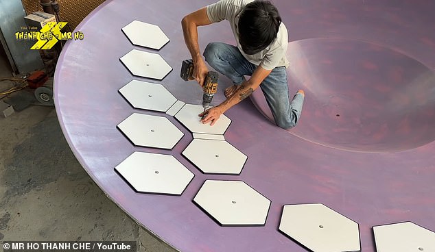 By laying fiberglass over the mold, the builders create a dish-shaped form. Mr. Ho then attaches a pattern of hexagonal planks to provide structure and mark the location of future panels