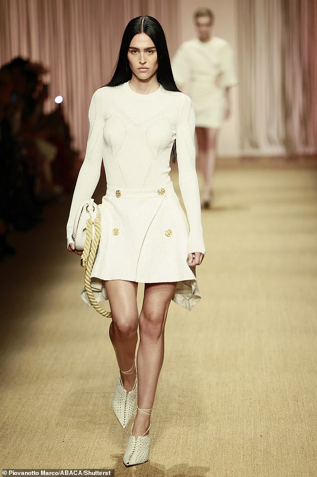 Amelia walked the Roberto Cavalli fashion show in an all-cream outfit before switching to a more daring dress