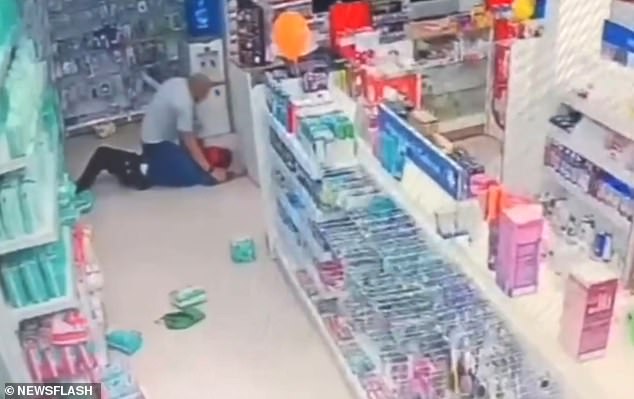 Security footage from inside the store shows him knocking the first thief, a girl, to the ground with a series of punches