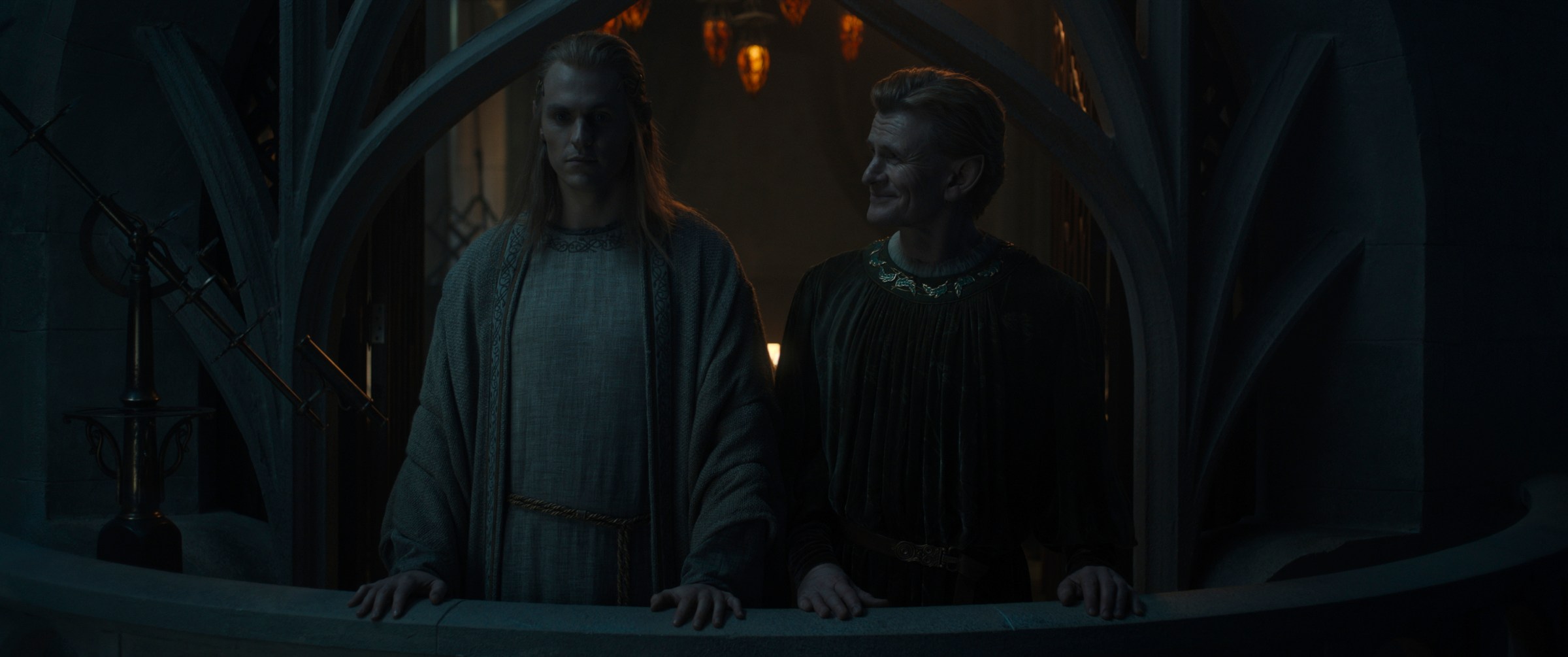 Charlie Vickers as Annatar and Charles Edwards as Celebrimbor stand on a balcony in Rings of Power 