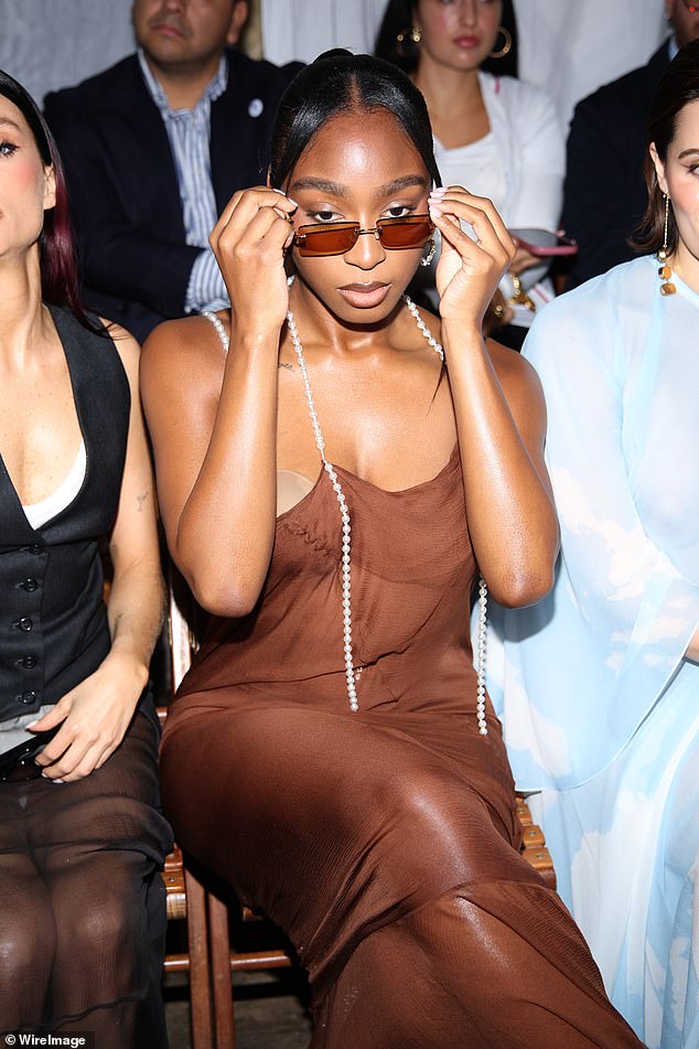 She completed her FROW look with a pair of silver, diamond-encrusted hoop earrings and wore orange-tinted sunglasses