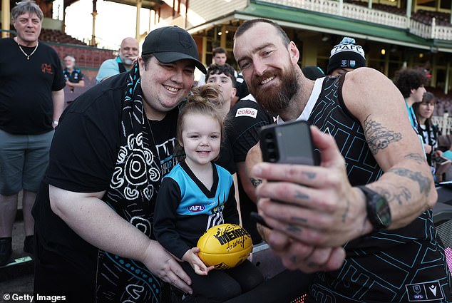 The setback will have left some Power fans panicking about how they will get to the SCG in time for the match (pictured supporters with Port star Charlie Dixon)