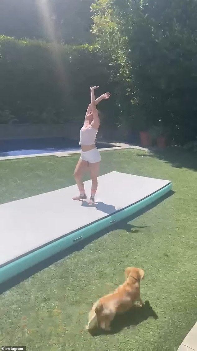 Dressed in white shorts and a yellow tank top, Charlotte is seen proudly performing a cartwheel for her mother