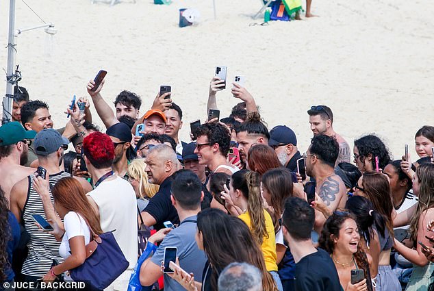 He was swarmed by over-enthusiastic fans as he left the beach, but thankfully he had security guards to keep them at bay.