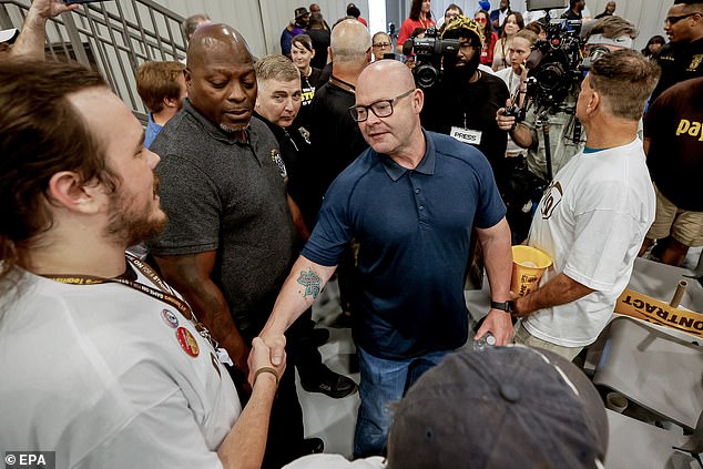 Sean O'Brien (C), general president of the International Brotherhood of Teamsters, announced the union's stunning decision not to endorse, prompting unions in swing states to issue their own endorsements