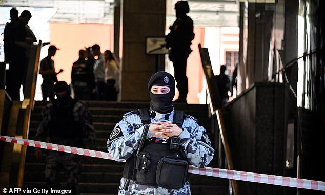 A Russian police officer blocks the entrance to the Wildberries office building on Wednesday