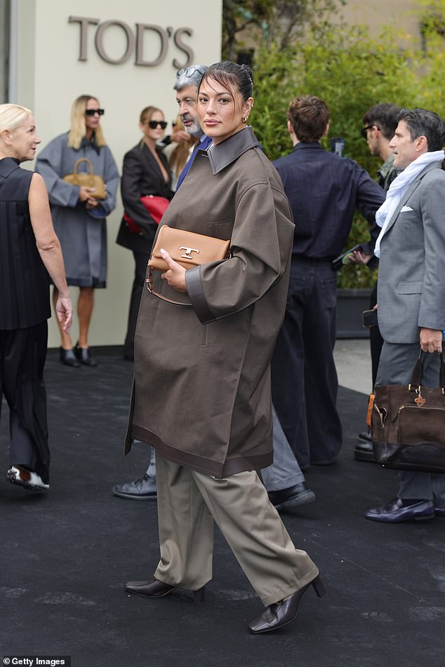 The model added a dark brown wax jacket and a pair of matching gray loafers to the casual outfit