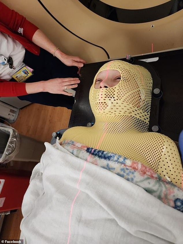 Mrs Rhodes was in and out of hospital for nine months undergoing chemotherapy and radiotherapy to treat her cancer. She is pictured above undergoing treatment