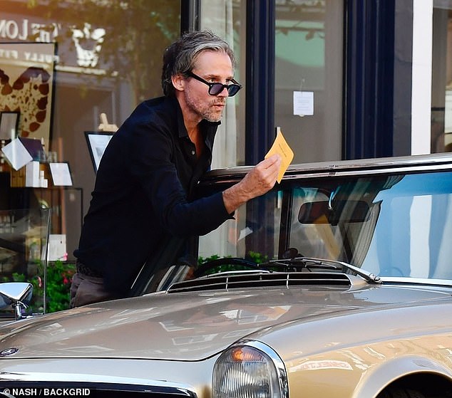 Jason picked up the parking ticket before pulling a face to express his frustration