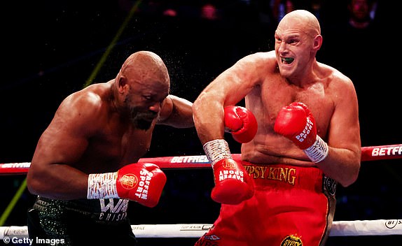 LONDON, ENGLAND - DECEMBER 3: Tyson Fury (R) punches Derek Chisora ​​​​(L) during the WBC World Heavyweight Title fight between Tyson Fury and Derek Chisora ​​​​at Tottenham Hotspur Stadium on December 3, 2022 in London, England. (Photo by Warren Little/Getty Images)