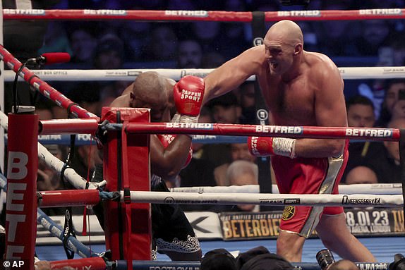 FILE - Tyson Fury, right, throws a punch during his WBC heavyweight championship boxing match against Derek Chisora ​​at Tottenham Hotspur's White Hart Lane stadium in London, December 3, 2022. Tyson Fury will face Oleksandr Usyk in Saudi Arabia in the first fight this century to unify all four major heavyweight boxing titles, Fury's promoter Frank Warren said Friday, September 29, 2023. (AP Photo/Ian Walton, File)