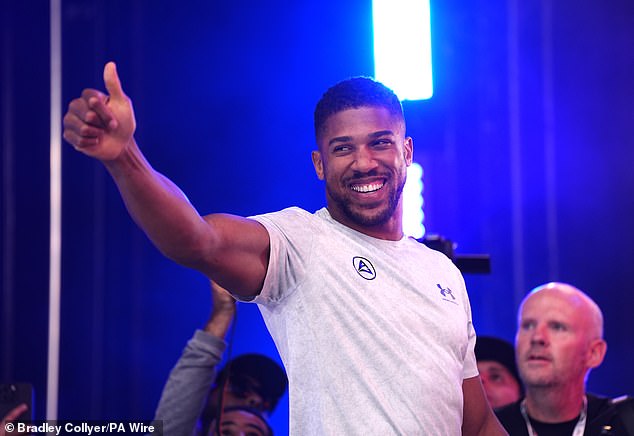 Joshua was all smiles as he emerged from Trafalgar Square for the weigh-in to loud cheers