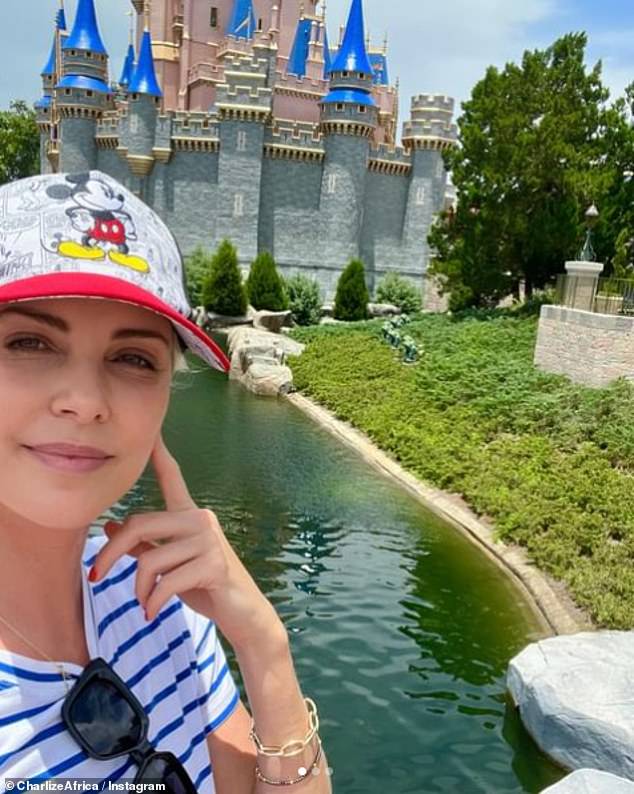 The South African-born beauty beamed in a selfie, showing off her Mickey Mouse hat and blue and white striped top