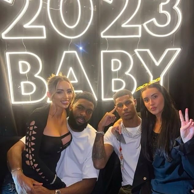 Rashford pictured at a party with friends, posing for the camera outside the football pitch