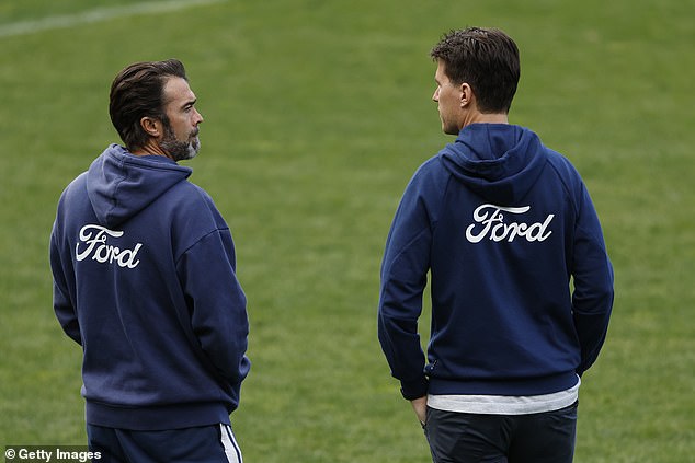 Geelong Cats coach Christ Scott speaks to general manager of football Andrew Mackie during the training session