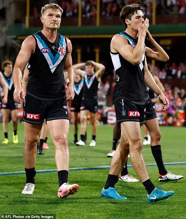 After the match, Port Adelaide coach Ken Hinkley had to clean up after another blockage in September (pictured left, a broken Ollie Wines)