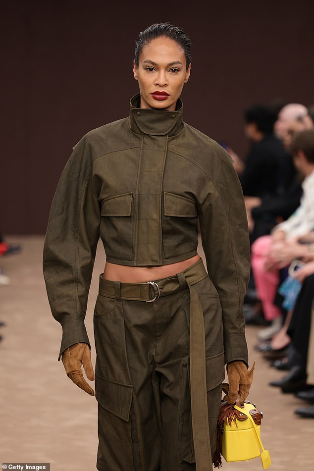 Elsewhere at the show, Joan Smalls looked typically chic in a dark green two-piece as she showed off her skills on the runway