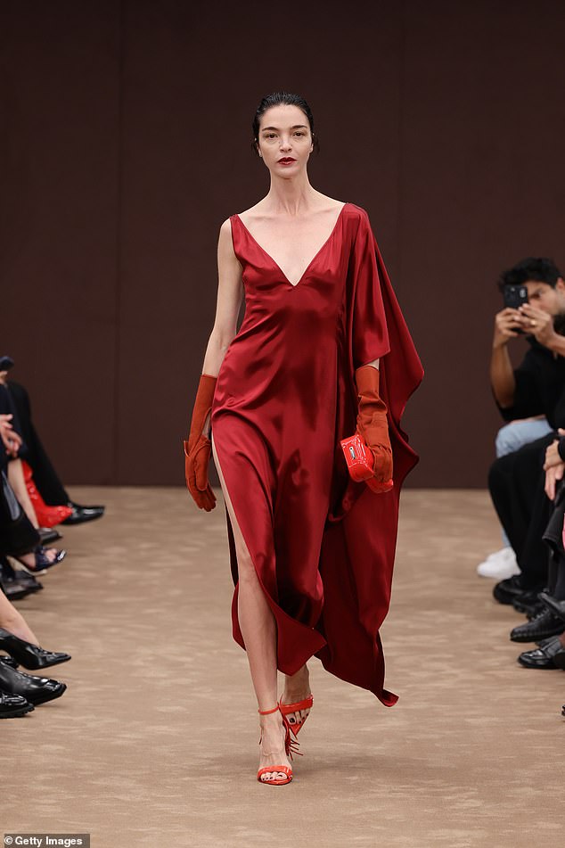 Italian model Mariacarla Boscono, 44, turned heads in a dramatic red dress with a plunging neckline and a thigh-high slit