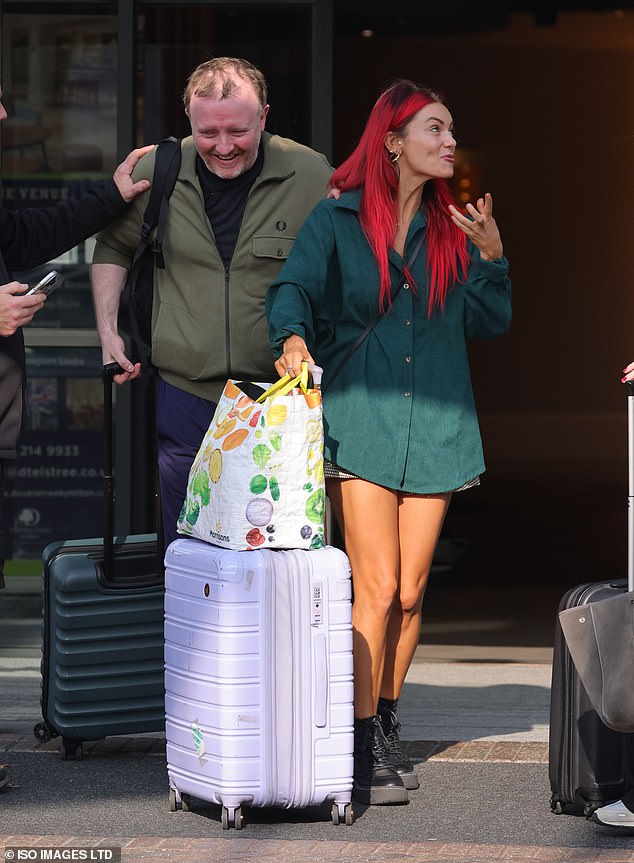 With their luggage in tow, the 47-year-old blind comedian said something clearly funny while the 35-year-old red-haired dancer tilted her head back and laughed heartily