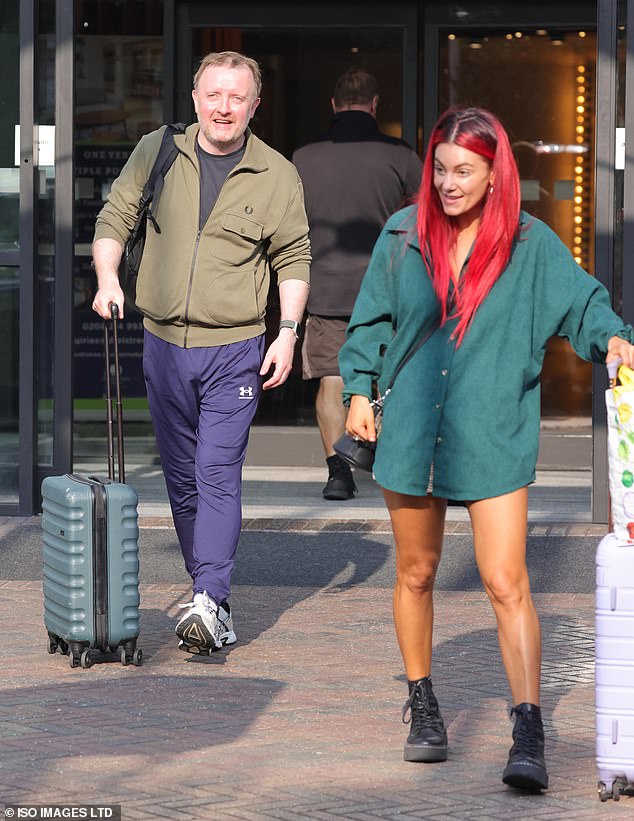 Dianne showed off a tall mannequin as she rolled her suitcase out, wearing a green shirt with very short shorts and black boots