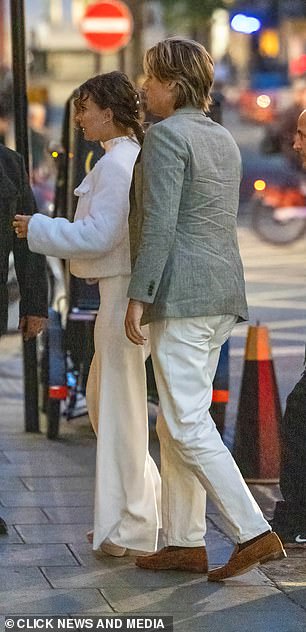 The actress, 20, looked typically chic in a white wedding dress as she left hand-in-hand with Jake, 22