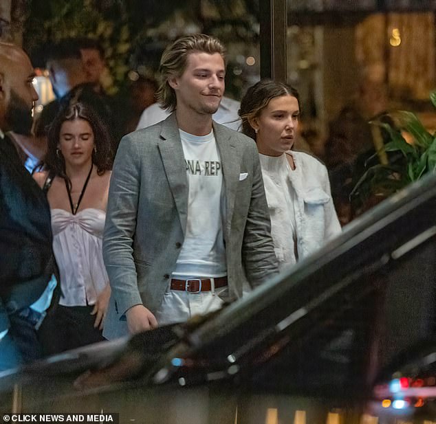 Millie wore a sparkly white halter top and pants, paired with platform heels