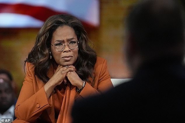 Oprah Winfrey, joined by Democratic presidential candidate and Vice President Kamala Harris, listens to an audience member