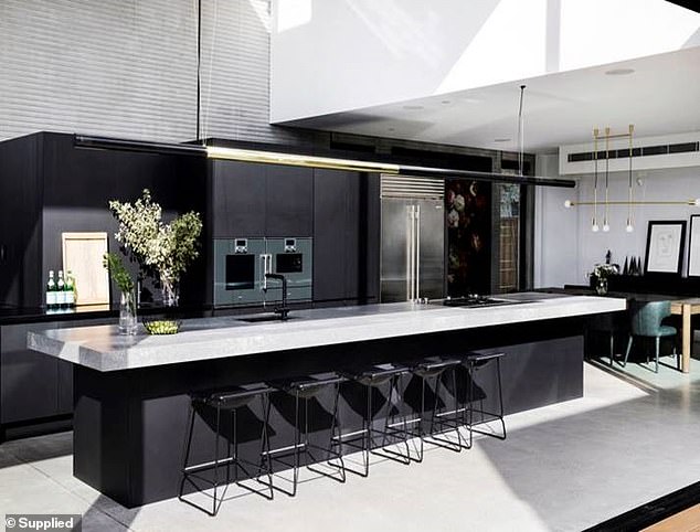 The Voice judge and his wife Jules wanted to create a sleek kitchen space, featuring Caesarstone benches and Supa Black cabinets throughout the space, to complement the urban industrial materials used throughout the home.