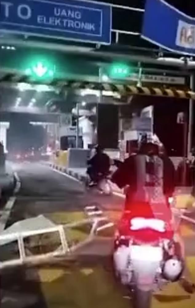 Shocked police officers stopped at the destroyed toll barrier as the truck sped away