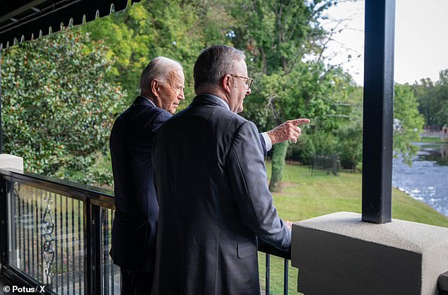 Biden points out the lake to Albanese while giving him a tour of his home