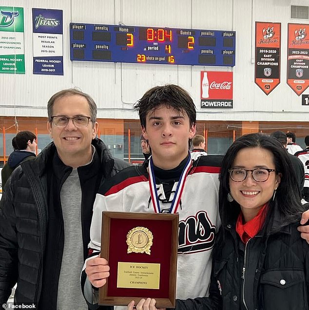 Elliot is seen here with his parents Scott Kropf and Ngoc Dinh. 