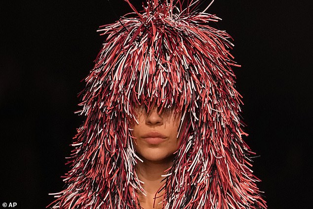 The brightly colored headpieces appeared to cover the models' eyes, with some falling well below the shoulders