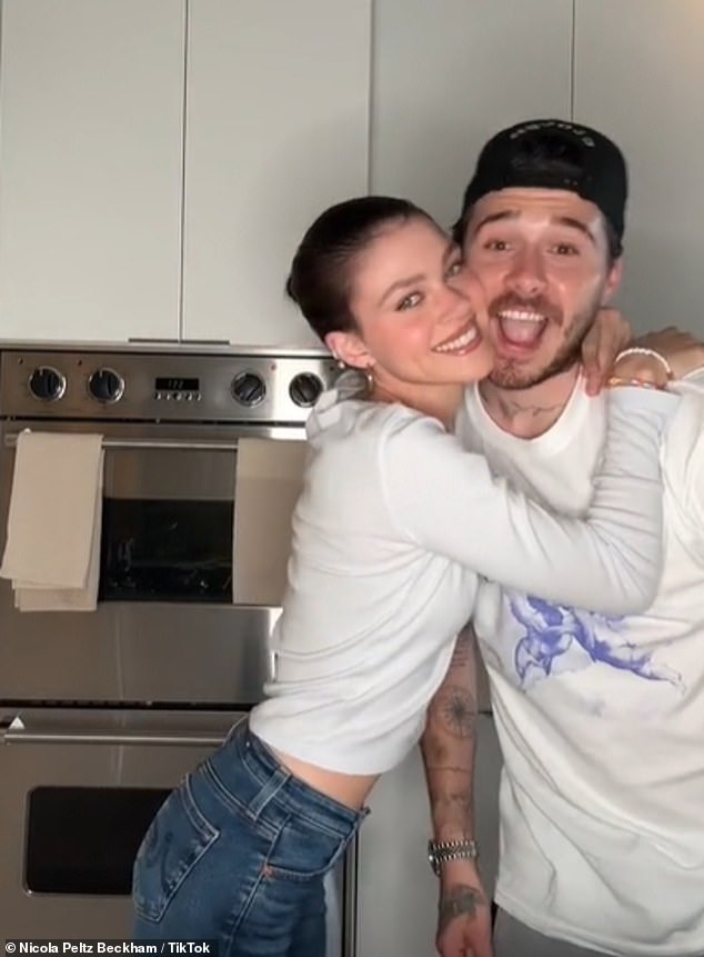 In the video, the beauty is seen dancing in her kitchen with her husband Brooklyn before picking up and cuddling her puppy