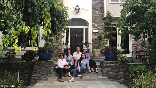 Leach is pictured with her parents outside their old San Diego home, which they sold to buy the castle