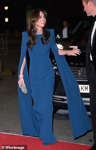 A vision in emerald green, her figure-hugging cape dress was strikingly similar to the slinky Safiyaa gown Kate wore to the Royal Variety Performance last year